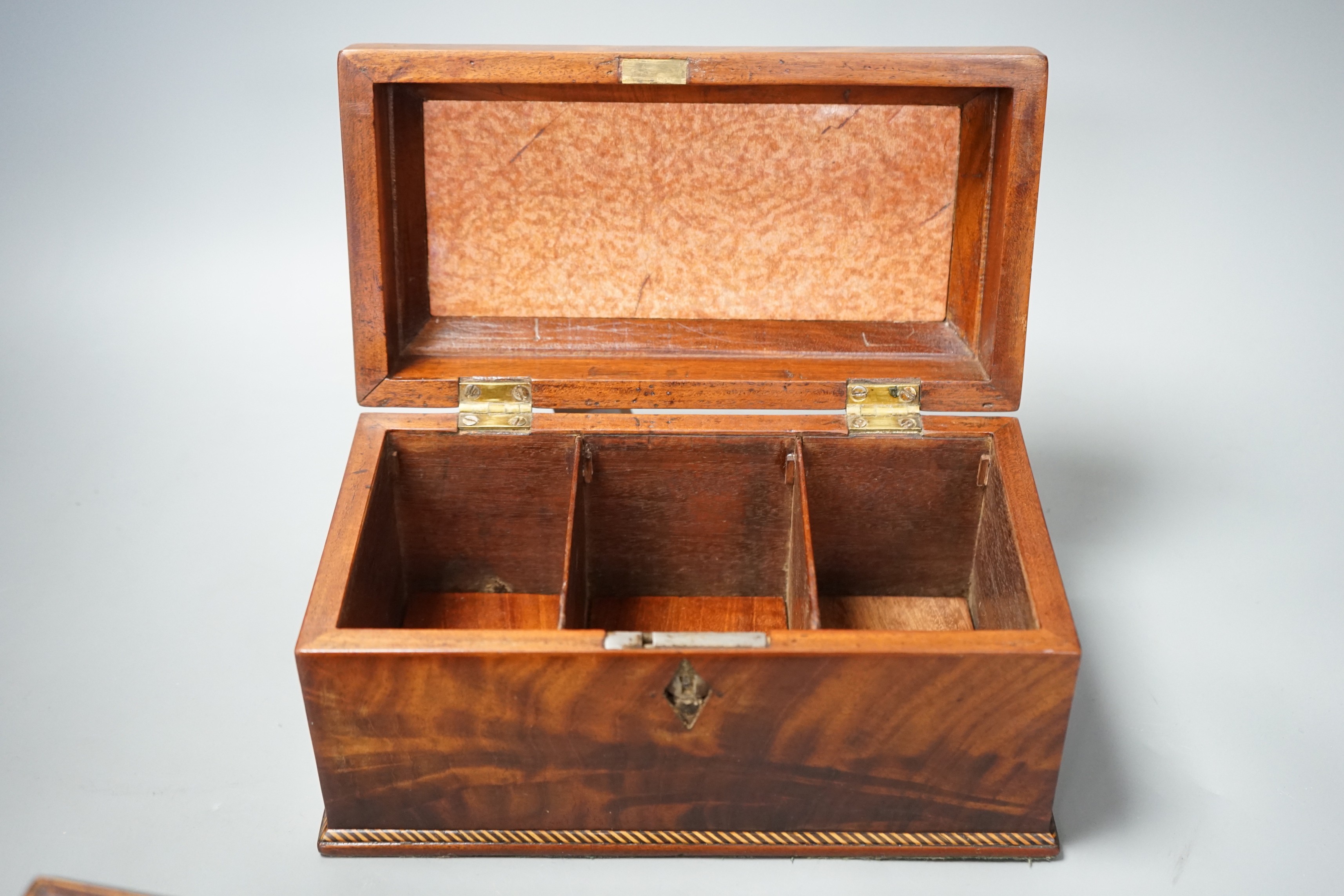 Two George III mahogany tea caddies, one with an inlaid satinwood ribbon and the other, 25cm